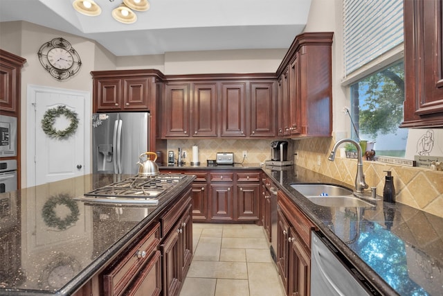 11409 E Zoe Loop Dr, Montgomery, TX 77316 - kitchen featuring appliances with stainless steel finishes, a sink, tasteful backsplash, and dark stone countertops