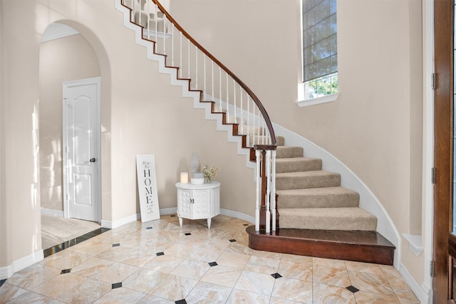 11409 E Zoe Loop Dr, Montgomery, TX 77316 - stairs with a high ceiling, arched walkways, and baseboards