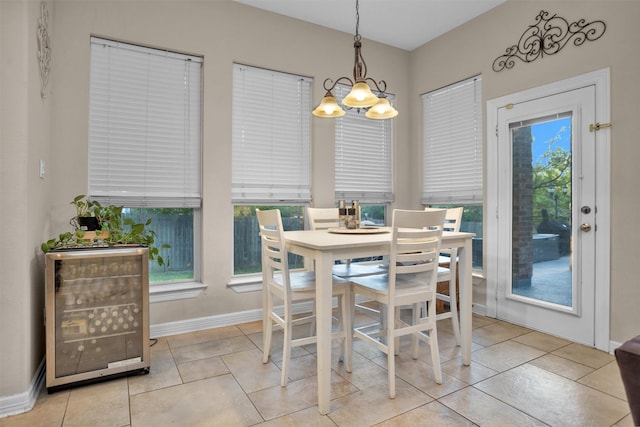 11409 E Zoe Loop Dr, Montgomery, TX 77316 - dining room featuring a chandelier, baseboards, beverage cooler, and plenty of natural light