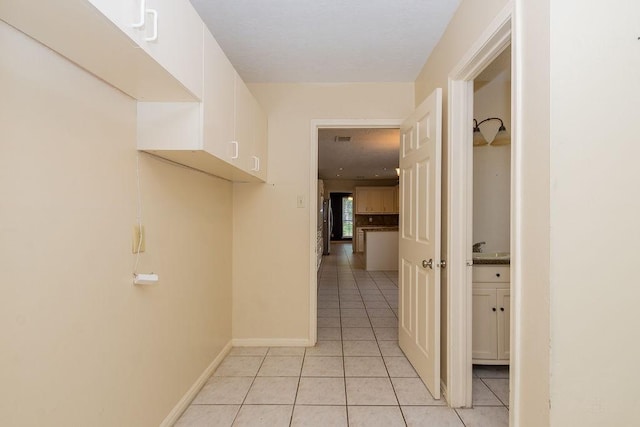 1103 Suwanee Ln, Houston, TX 77090 - hallway featuring baseboards, visible vents, and light tile patterned floors