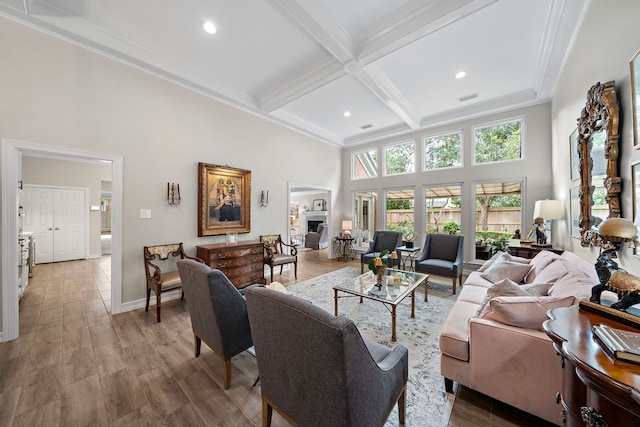 living room with visible vents, ornamental molding, beam ceiling, a high ceiling, and recessed lighting