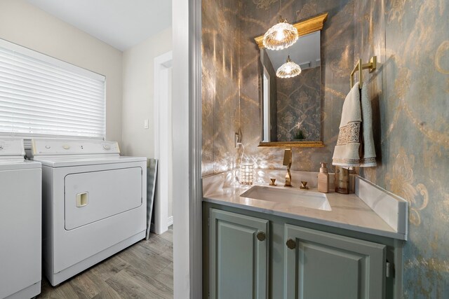 washroom with washer and clothes dryer and a sink