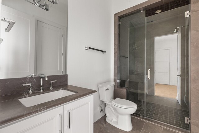 1323 Peden St, Houston, TX 77006 - full bath featuring a stall shower, tile patterned floors, vanity, and toilet