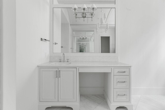 1323 Peden St, Houston, TX 77006 - bathroom featuring baseboards, marble finish floor, and vanity