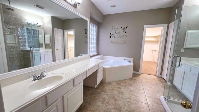 bathroom featuring visible vents, a shower stall, a bath, and tile patterned flooring