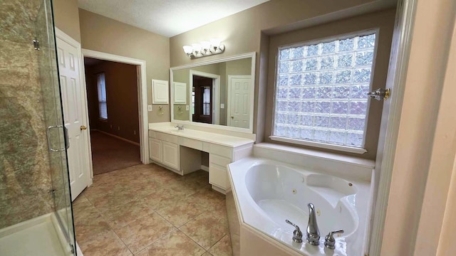 full bath with a whirlpool tub, vanity, a shower stall, and tile patterned floors
