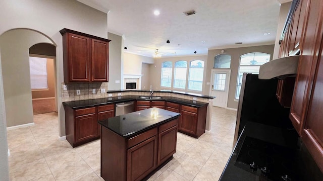 kitchen with a sink, ceiling fan, visible vents, a peninsula, and stainless steel dishwasher