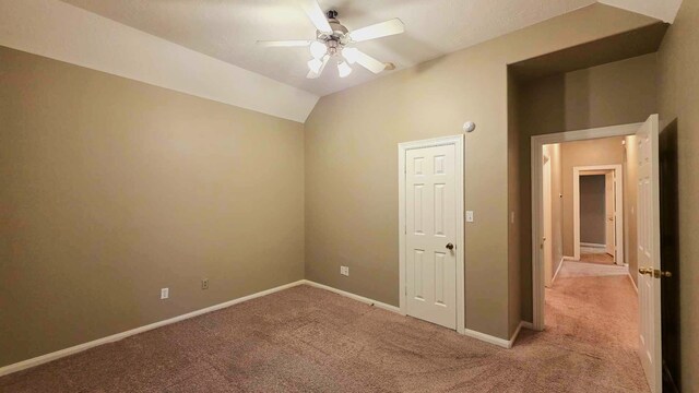 unfurnished room featuring light colored carpet, ceiling fan, and baseboards