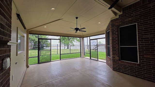 unfurnished sunroom with ceiling fan