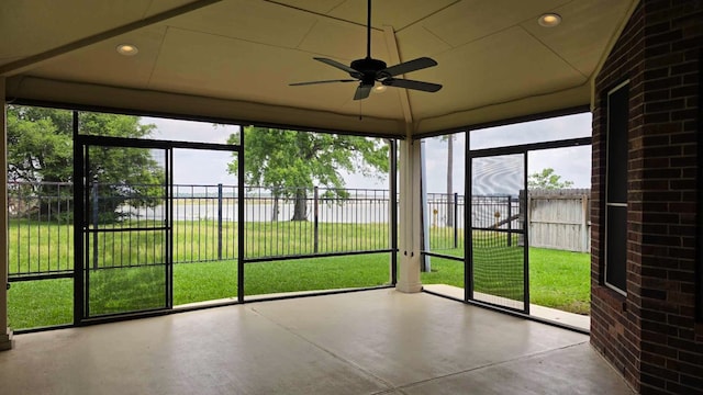 unfurnished sunroom featuring a water view