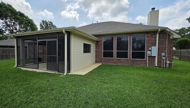 8931 Pine Shores Dr, Humble, TX 77346 - back of house with a chimney, a sunroom, and brick siding