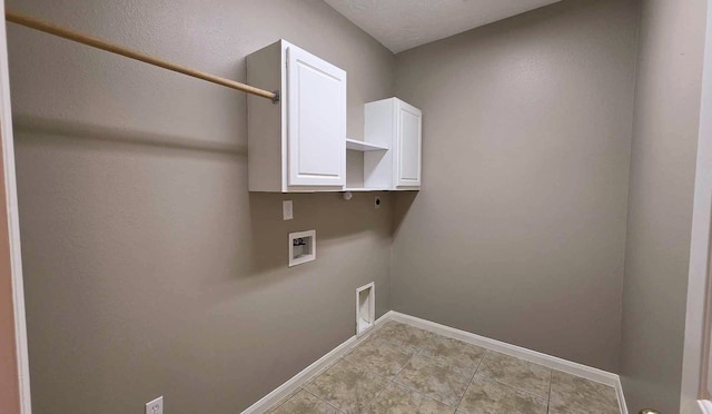 clothes washing area with hookup for an electric dryer, cabinet space, light tile patterned floors, washer hookup, and baseboards