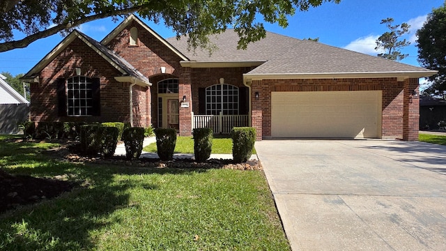 8931 Pine Shores Dr, Humble, TX 77346 - view of front of property featuring brick siding, a garage, a front lawn, and driveway