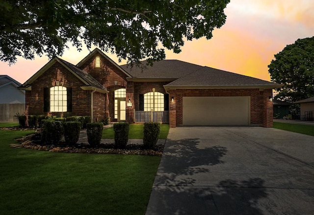 8931 Pine Shores Dr, Humble, TX 77346 - view of front of property with an attached garage, brick siding, and a yard