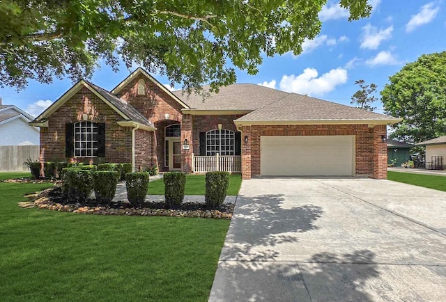 8931 Pine Shores Dr, Humble, TX 77346 - view of front of property with brick siding, an attached garage, driveway, and roof with shingles