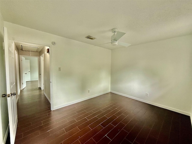 8818 Fern Valley Dr, Houston, TX 77044 - spare room featuring attic access, a ceiling fan, baseboards, dark wood finished floors, and a textured ceiling