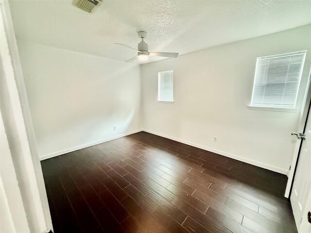 8818 Fern Valley Dr, Houston, TX 77044 - unfurnished room featuring ceiling fan, a textured ceiling, baseboards, and dark wood finished floors