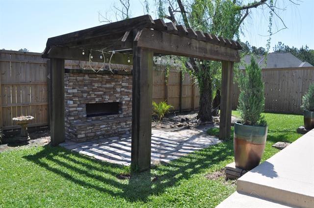 view of patio with a pergola, a fenced backyard, and an outdoor fireplace