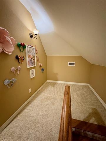 additional living space featuring lofted ceiling, visible vents, carpet floors, and baseboards