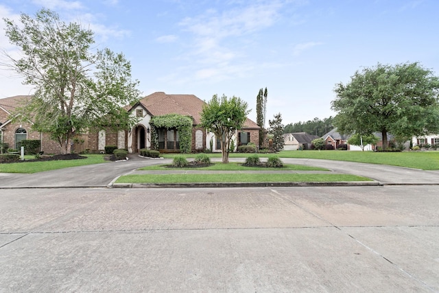 101 Sir Cameron, Lumberton, TX 77657 - view of front of property featuring curved driveway and a front lawn