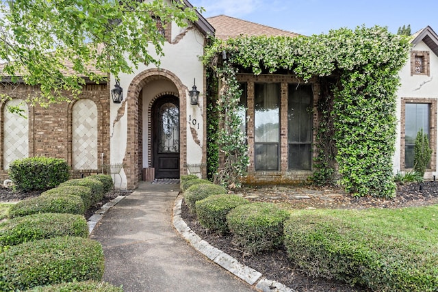 101 Sir Cameron, Lumberton, TX 77657 - property entrance featuring stucco siding, roof with shingles, and brick siding