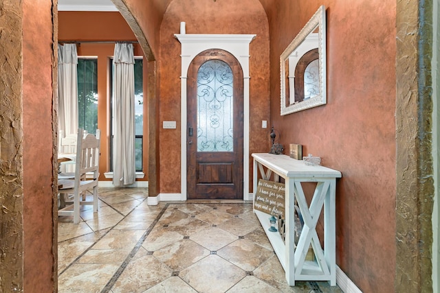 101 Sir Cameron, Lumberton, TX 77657 - entrance foyer with arched walkways, inlaid floor details, and baseboards