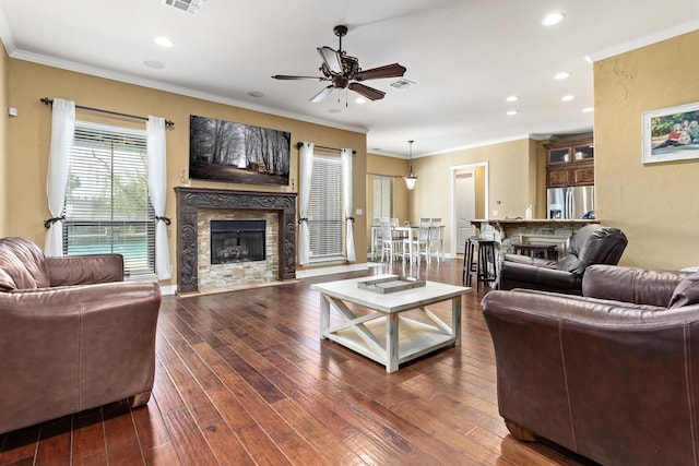 101 Sir Cameron, Lumberton, TX 77657 - living room featuring a tiled fireplace, a ceiling fan, hardwood / wood-style flooring, recessed lighting, and crown molding
