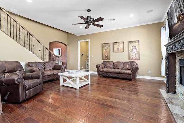 101 Sir Cameron, Lumberton, TX 77657 - living area with arched walkways, a fireplace, dark wood finished floors, stairway, and crown molding