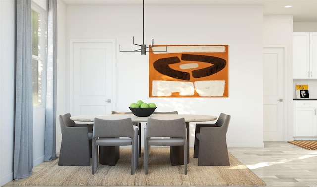 dining space with baseboards, recessed lighting, light wood finished floors, and an inviting chandelier