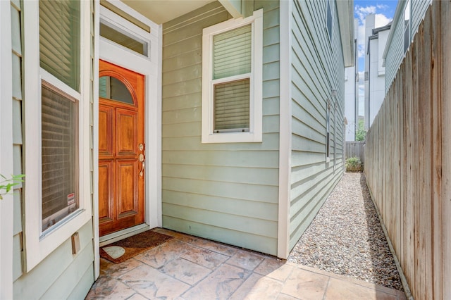 doorway to property featuring fence