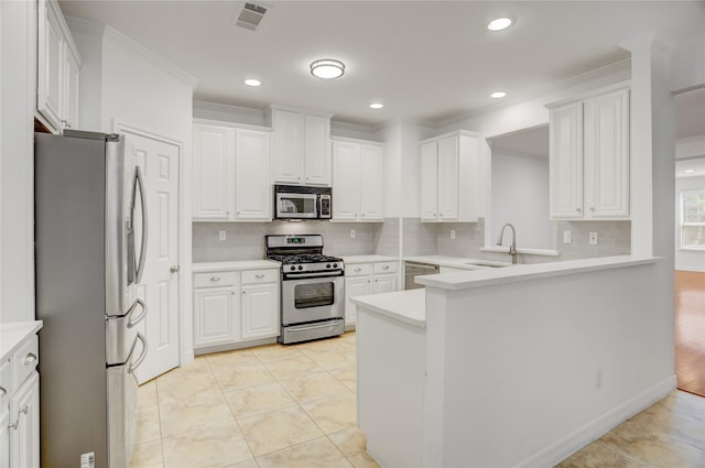 kitchen with decorative backsplash, visible vents, a sink, and appliances with stainless steel finishes