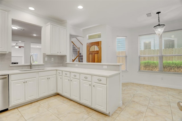 kitchen featuring light countertops, backsplash, stainless steel dishwasher, ornamental molding, and a sink