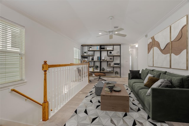 living area with visible vents, ornamental molding, and ceiling fan
