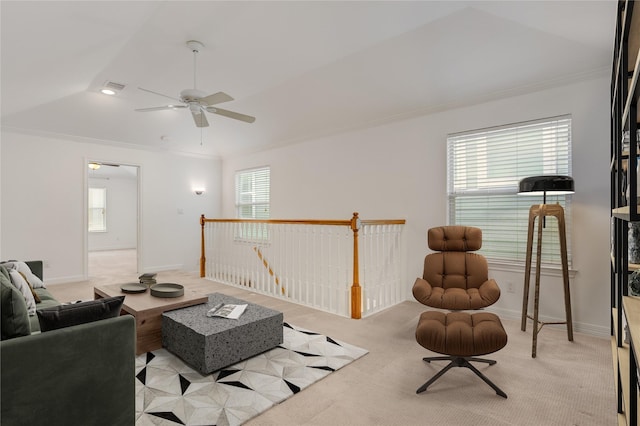 living room featuring visible vents, crown molding, baseboards, light colored carpet, and ceiling fan