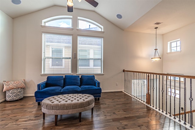 living area with vaulted ceiling, hardwood / wood-style floors, visible vents, and ceiling fan