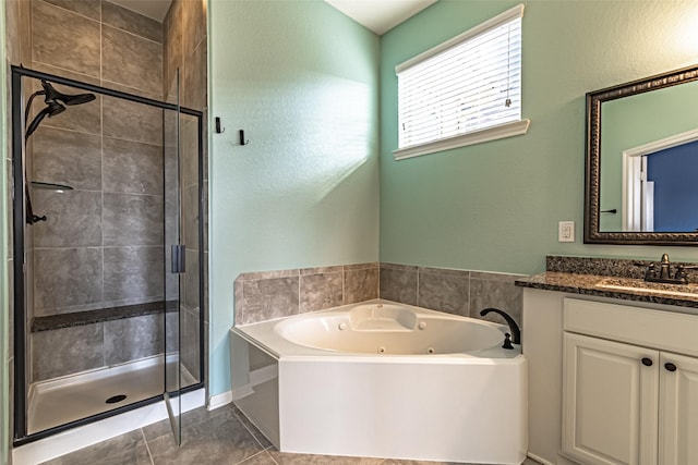 full bathroom featuring tile patterned floors, vanity, a whirlpool tub, and a stall shower