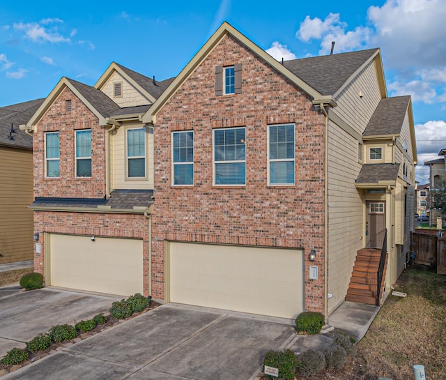 view of front of property with brick siding, an attached garage, and concrete driveway
