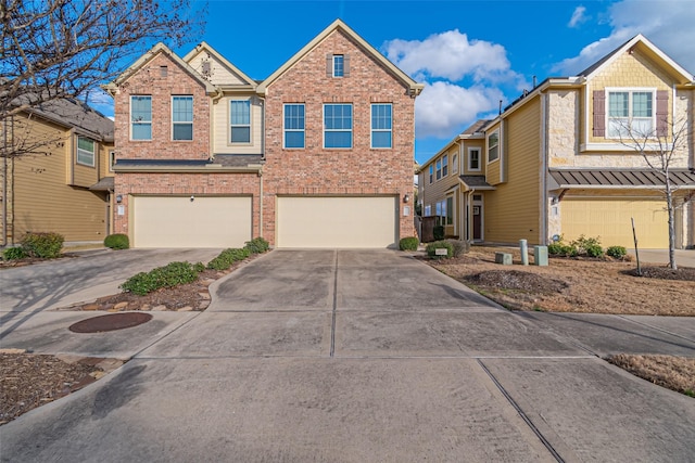 view of front of property featuring an attached garage, driveway, and brick siding