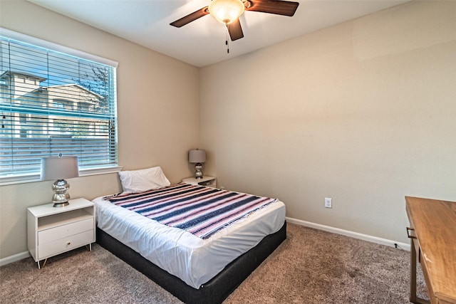 carpeted bedroom with a ceiling fan and baseboards