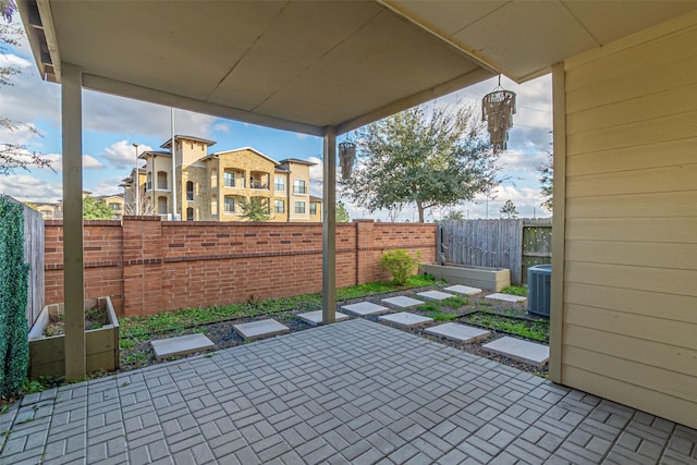 view of patio / terrace featuring fence and central air condition unit