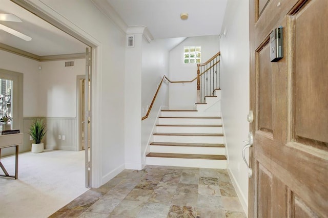 staircase featuring baseboards, a ceiling fan, visible vents, and stone finish floor