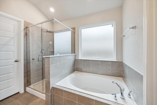 full bathroom featuring a garden tub, tile patterned flooring, and a shower stall