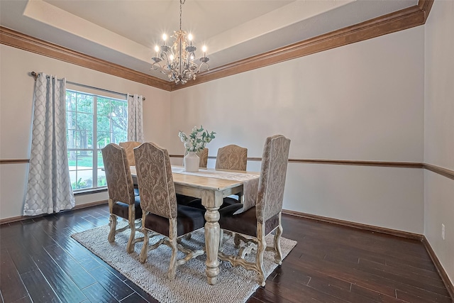 dining space featuring an inviting chandelier, baseboards, hardwood / wood-style floors, and a tray ceiling