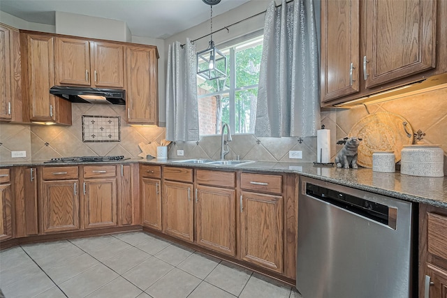 kitchen featuring a sink, brown cabinets, stainless steel appliances, and under cabinet range hood