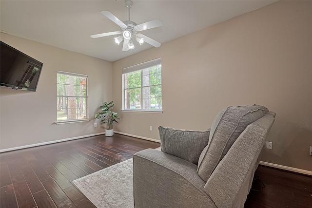 sitting room featuring baseboards, wood finished floors, and ceiling fan
