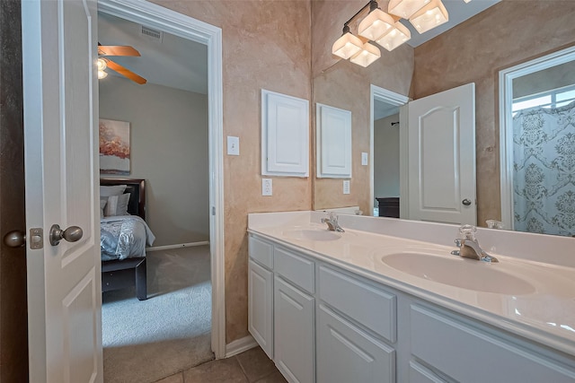 ensuite bathroom with tile patterned floors, double vanity, ensuite bathroom, and a sink