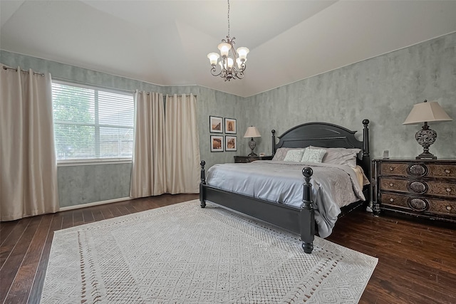 bedroom featuring a notable chandelier, lofted ceiling, and wood-type flooring
