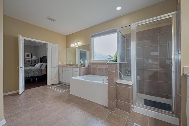 full bath featuring visible vents, ensuite bathroom, tile patterned floors, a garden tub, and vanity
