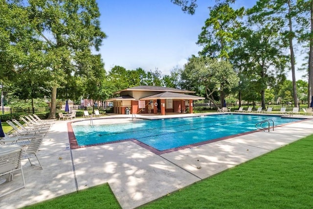 pool with fence and a patio