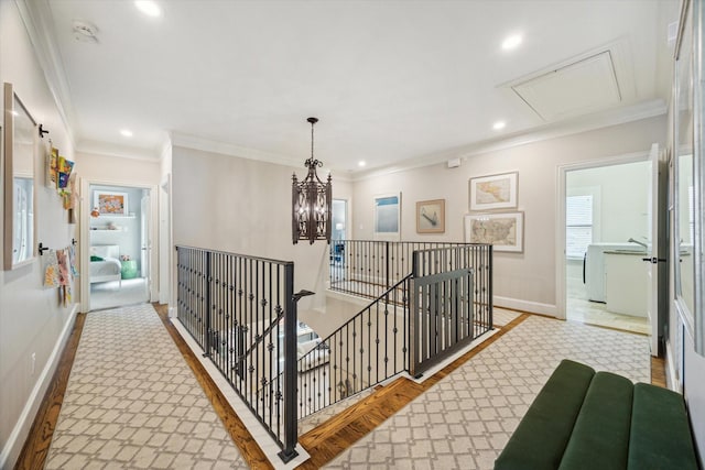 hall featuring attic access, baseboards, an upstairs landing, ornamental molding, and recessed lighting